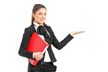 A Young Businesswoman Holding A Folder And Gesturing