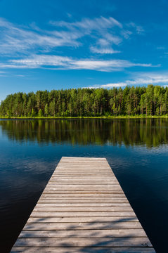 wooden pier on lake symmetrical scene