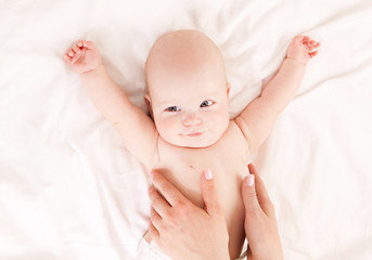 mother massaging baby