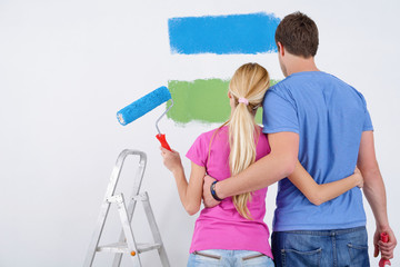 Wall Mural - happy couple paint wall at new home