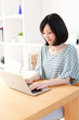 © taka - a young asian woman using laptop computer
