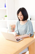 © taka - a young asian woman using laptop computer