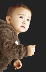 portrait of a handsome kid wearing a brown bear sweatshirt and l