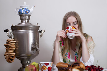 Wall Mural - Russian girl drinking tea with samovar