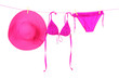 © Africa Studio - Women's swimsuit and hat hanging on a rope on white background