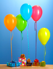 colorful balloons holding a gifts