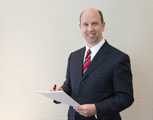 Smiling business man with document.