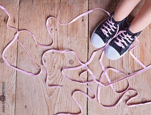 The problem - childs feet and long twisted shoelaces Poster Mural XXL