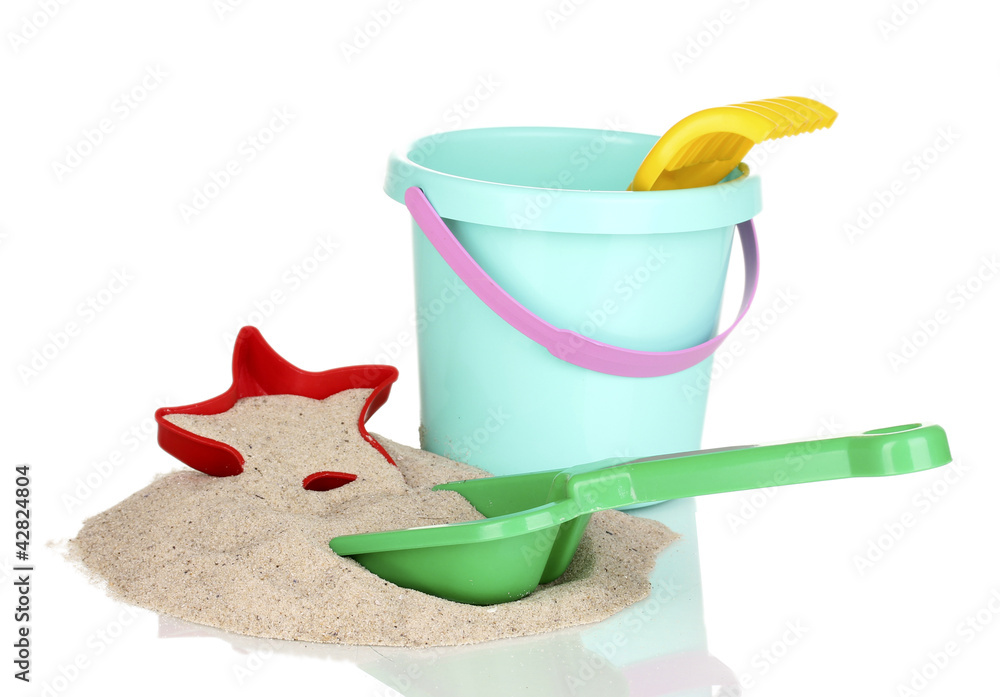 Children's beach toys and sand isolated on white