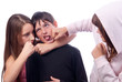 Two teenage girls beating teenage boy