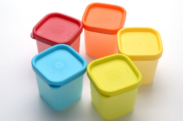 colorful plastic containers isolated on white background