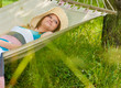 © stormy - beautiful woman outdoors in summer on hammock