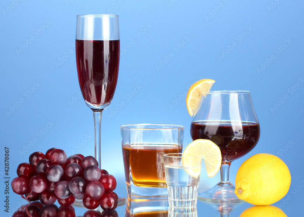 a variety of alcoholic drinks on blue background