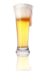 Frosty glass of light beer with foam isolated