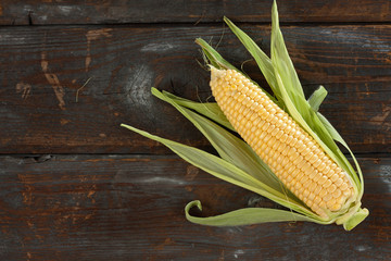 Wall Mural - A corn cob on a wooden table