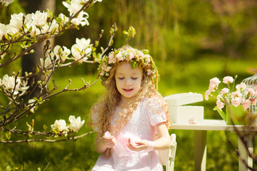 Little girl in spring garden wearing a chaplet