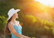 © Alliance - Portrait of happy woman on vacation enjoying sunset