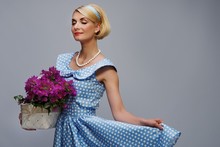Lovely Woman In A Blue Dress With A Basket Of Flowers