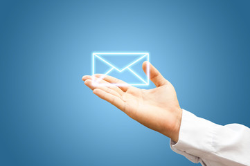 Hand with mail symbol on blue background