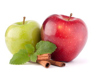 Red and green apples, cinnamon sticks and mint leaves still life