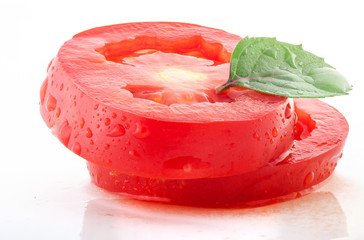 Poster - Tomato slices and green leaf of basil isolated on white