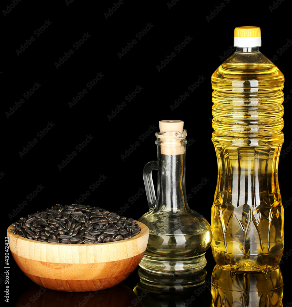 sunflower oil in bottles isolated on black background