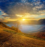 Fototapeta Natura - sunrise above a mountain valley