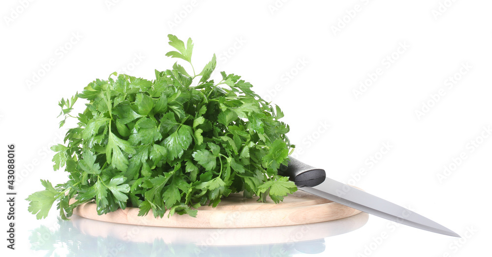 Parsley on a cutting board with knife isolated on white