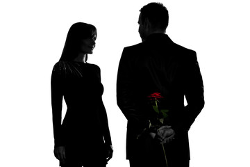 one couple man hiding rose flower and woman smiling