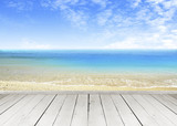 Fototapeta  - Wooden terrace looking out over a tropical cloud sky and seaview