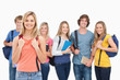 © WavebreakmediaMicro - A smiling girl stands in front of her college friends