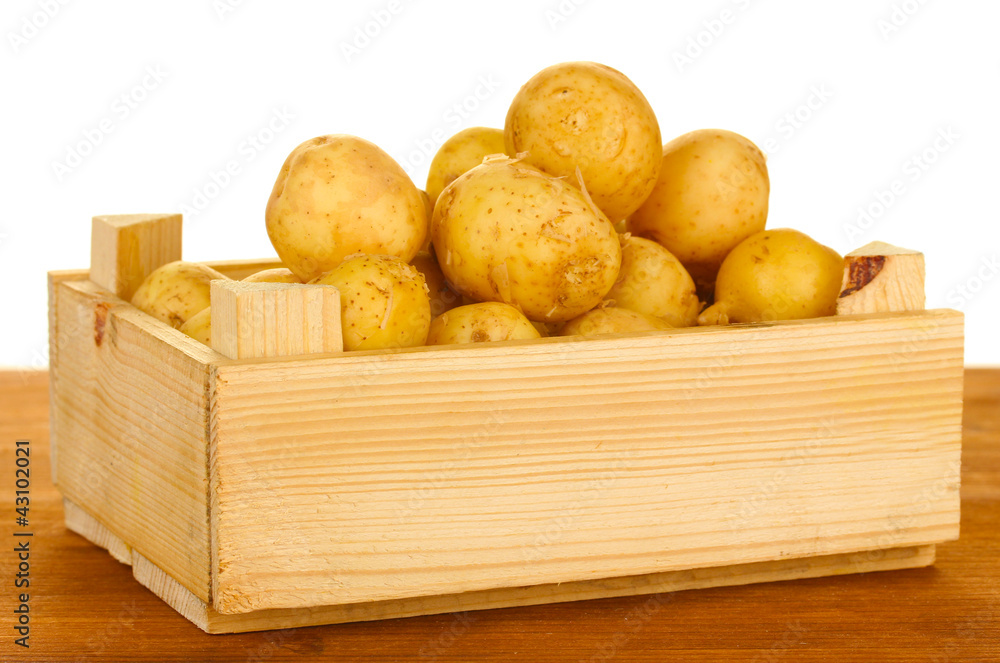 young potatoes in a wooden box