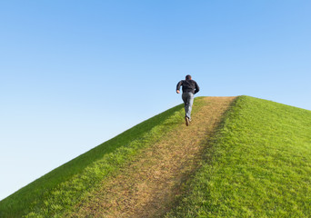 pathway up the hill against the sky. man ran to the top.