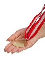 Wall Mural - hand holding gold medal on white