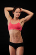 Muscular woman on black background