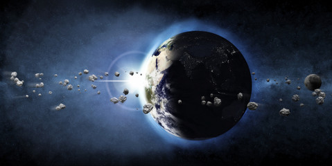 earth planet with rising sun and asteroid belt