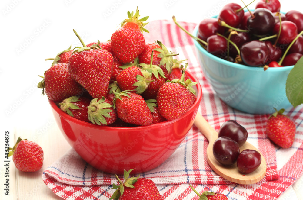 Ripe strawberries and cherry berries in bowls