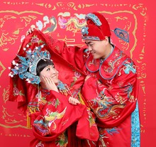 Chinese Young Couple Dressed In Traditional Wedding Suite In Typ