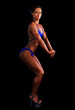 Muscular woman posing on black background