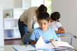 © goodluz - Children in class with teacher