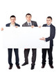 © GVS - Three young businessmen hold up a large blank sign isolated