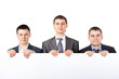 © GVS - Three young businessmen hold up a large blank sign isolated