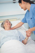 © WavebreakmediaMicro - Patient smiling to a nurse while holding her hand