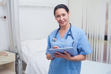 Wall Mural - Nurse using a tablet pc