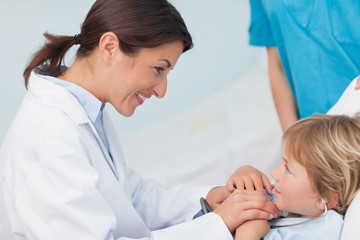 Wall Mural - Doctor holding hands of a child