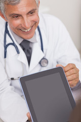 Wall Mural - Doctor holding a tablet computer while smiling