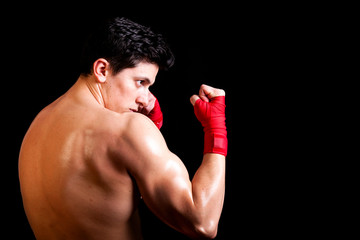 Young Boxer fighter over black background