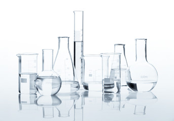 Set of classic laboratory flasks with a clear liquid, isolated