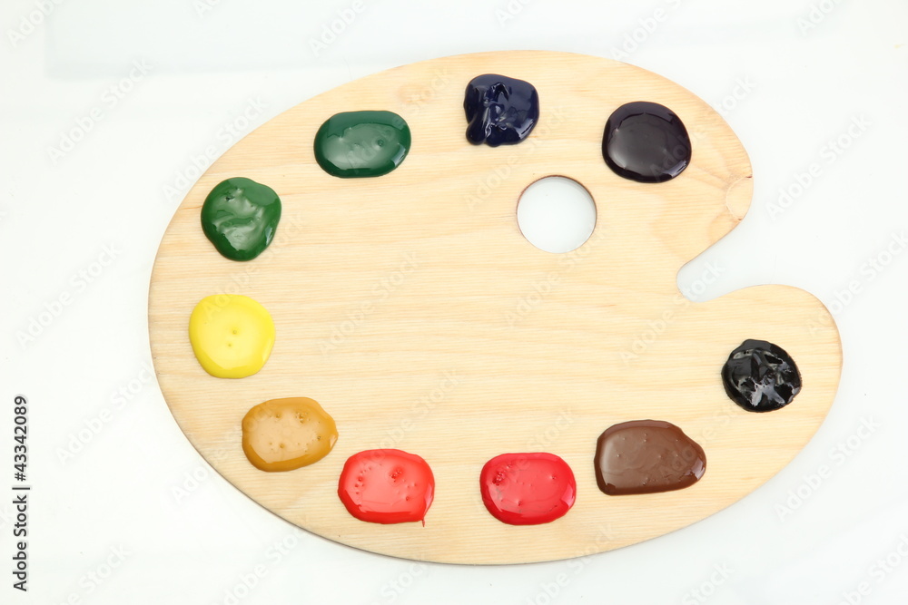 wooden art palette with paint isolated on white