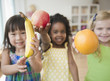 © JGI/Jamie Grill/Blend Images - Children holding out fresh fruit